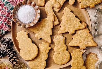 Light Spice Holiday Cookies on a plate with decorative holiday accents.
